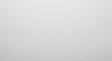 Close-up of white textured paper background with subtle grain and soft focus