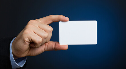 Fototapeta premium Businessman in suit holding a blank business card mockup