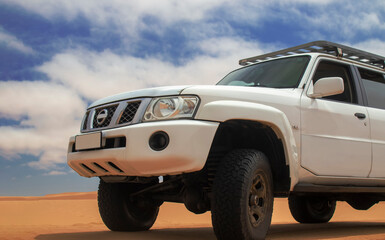 White 4x4 vehicle shot in detail against cloudy skies and desert terrain in Namibia. Perfect for...