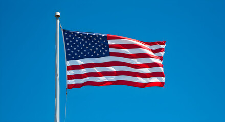 Obraz premium American Flag Waving Against Clear Blue Sky | Patriotism and National Symbol for Independence Day and Memorial Day Marketing Materials