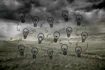 Light bulbs graphic on dark countryside
