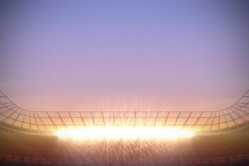 Large football stadium with spotlights at sunrise