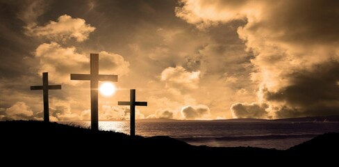 Cross religion symbol shape over sunset sky