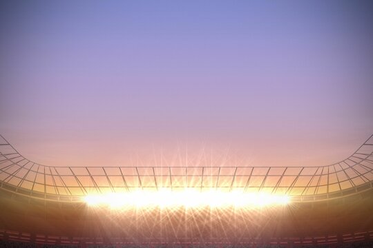 Fototapeta Large football stadium with spotlights at sunrise