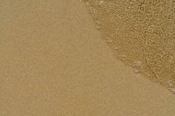 Experience the serenity of this beach scene with golden sand and gentle waves. A perfect representation of relaxation and nature s beauty, ideal for travel promotions and backgrounds.