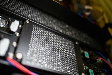Honeycomb mesh panel is being shown in 3D render interior, featuring fans, power connectors, cables