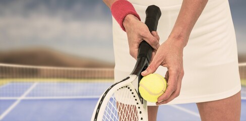 Midsection of sportswoman holding racket