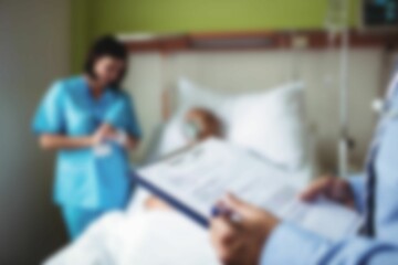 Doctors taking care of patient in hospital room