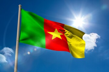 Cameroon national flag on blue sky background