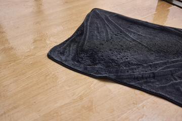 Using a Wet Cleaning Cloth on a Wooden Surface for Effective Maintenance and Care