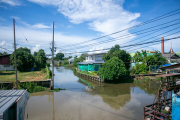 Serene Waterway with Lush Greenery and Sky