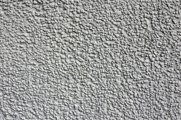 Rough stone stucco wall close-up abstract textured background