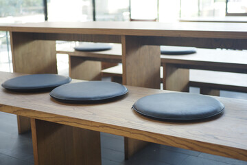 Modern wooden seating with round cushions in interior space