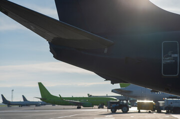 Airplane undergoing repairs in the open air.