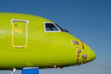 Airplane undergoing repairs in the open air.