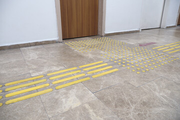 Floor guiding tactile paths in a corridor for accessibility