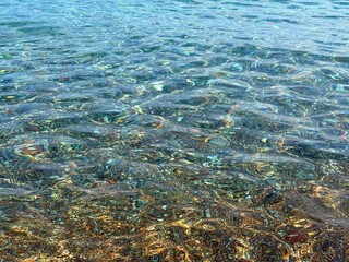 Crystal clear sea with pebbles at the bottom.