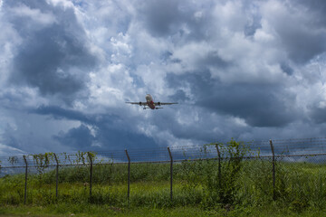 the security area of the airport and the plane flying in for landing