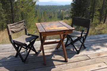 Rustic wooden table and chairs on deck overlooking forested mountain landscape. Portable Camping Chairs and Tables, cozy outdoor lifestyle concept