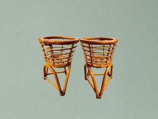 The light green background in the picture is a flower pot stand made from open rattan. It has three...