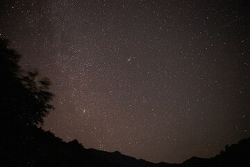 Bright night starry sky with millions of stars and galaxy Milky Way.