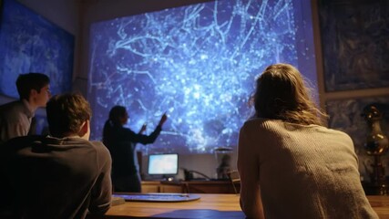 Group of students learning astronomy with projected constellation map  