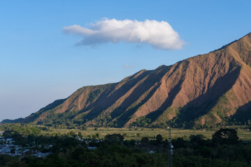 Majestic view of Pergasingan Hill glowing under soft morning light, seen from Selong Hill in Sembalun, Lombok—where dramatic ridgelines meet tranquil rural charm.
