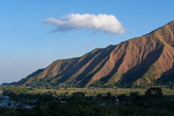 Majestic view of Pergasingan Hill glowing under soft morning light, seen from Selong Hill in Sembalun, Lombok—where dramatic ridgelines meet tranquil rural charm.