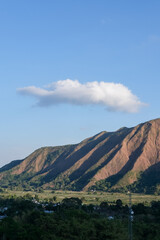 Majestic view of Pergasingan Hill glowing under soft morning light, seen from Selong Hill in Sembalun, Lombok—where dramatic ridgelines meet tranquil rural charm.