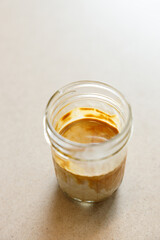 Cup of milk dirty coffee on table by the window.
