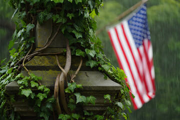 American flag at its base, where the pole meets a stone foundation