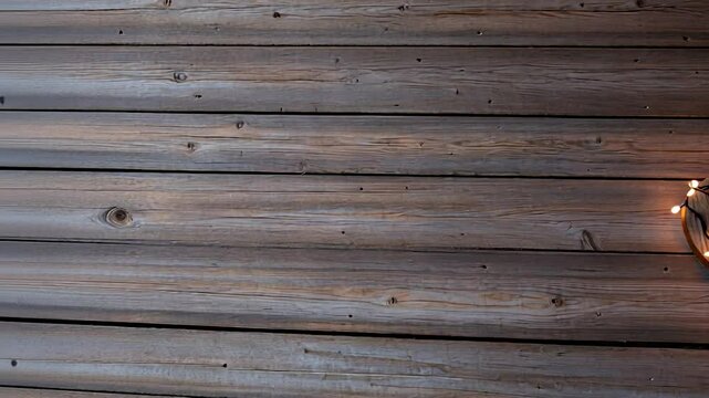 Wooden heart shape with glowing string lights on rustic timber planks background