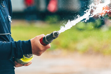Firefighter spraying water from the hose