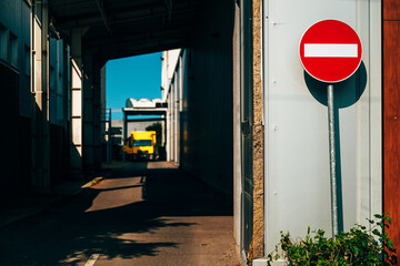 No entry sign at factory warehouse with truck in back