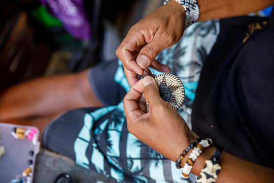 Mangyan Village in Talipanan Puerto Galera Oriental Mindoro Philippines closeup of hands making native ornament