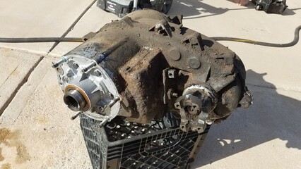 Transfer Case from a 1980s 4x4 SUV Sits on a Driveway 