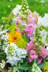 Wrapped flower bouquet made of mixed spring flowers. Beautiful pastel colored fresh flowers...