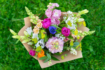 Wrapped flower bouquet made of mixed spring flowers. Beautiful vibrant colored fresh flowers...