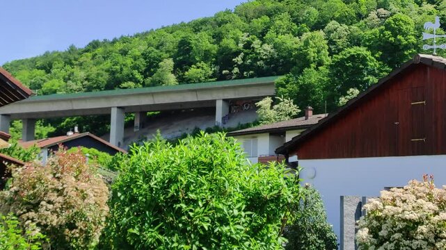 Freeway in-between homes and trees, A 59 in Southern Germany. Truck crossing the bridge.