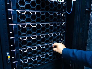 Hand Reaching for Server in Data Center