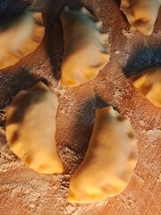 Hand-made dumplings made on a floured board