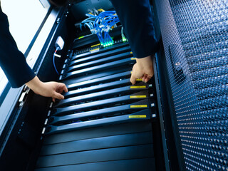 Hands Working on Server Rack Setup