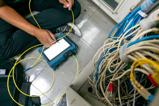 Technician Testing Network Cables and Connections