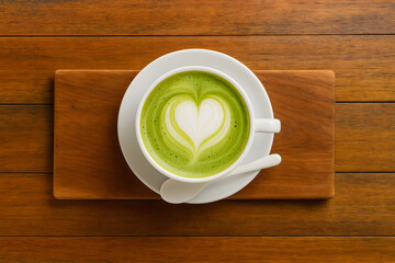 Obraz premium Matcha latte with heart latte art closeup cozy warm drink