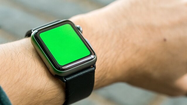 Close Up Smartwatch With Green Screen Display on Wrist Suitable for Wearable App Mockup Use and UI Design