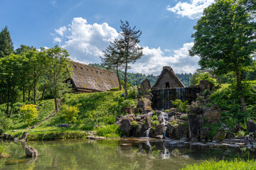 Traditional houses and waterfall pond in Shirakawa-go, Japan