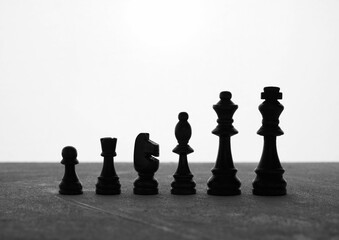 Black chess pieces standing on a gray surface