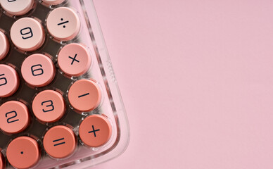 Pink calculator with big round buttons on pink background