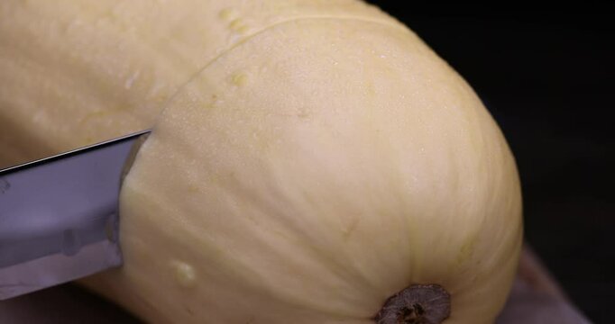 sliced white squash with a hard peel, ripe white squash on the kitchen table during cooking and slicing