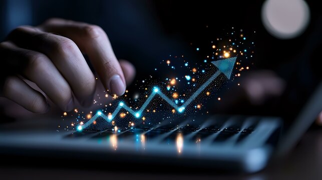 Glowing blue arrow chart trending upward with sparkles and light effects over laptop keyboard, showing business growth and success in digital technology.